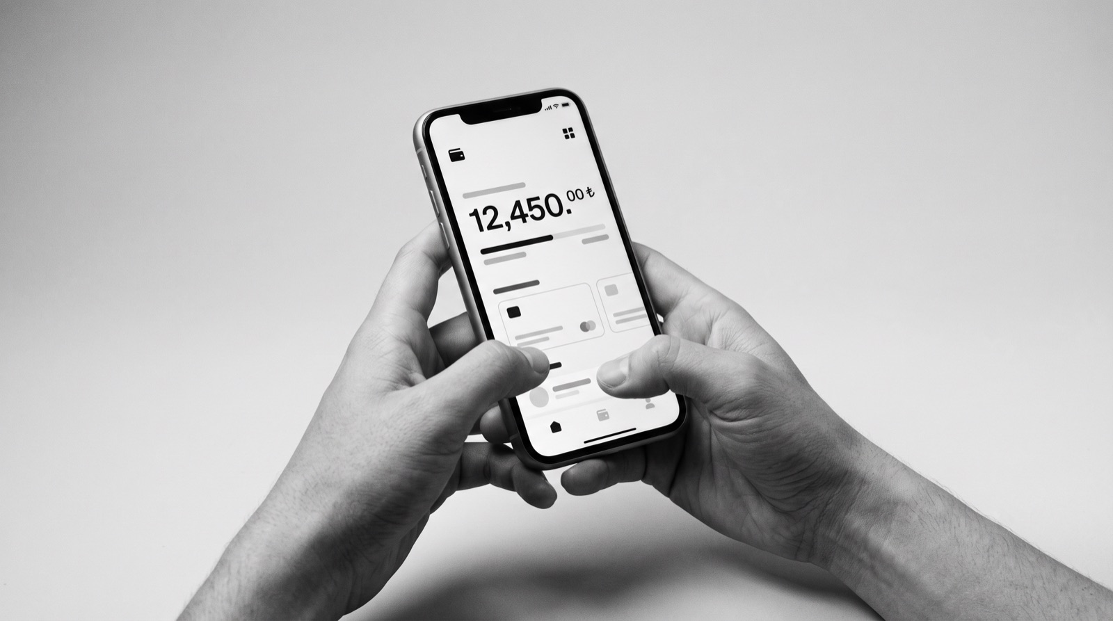 Two hands holding a phone that shows a banking app balance